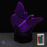 Wireframe butterfly-shaped LED lamp with remote control on a dark background