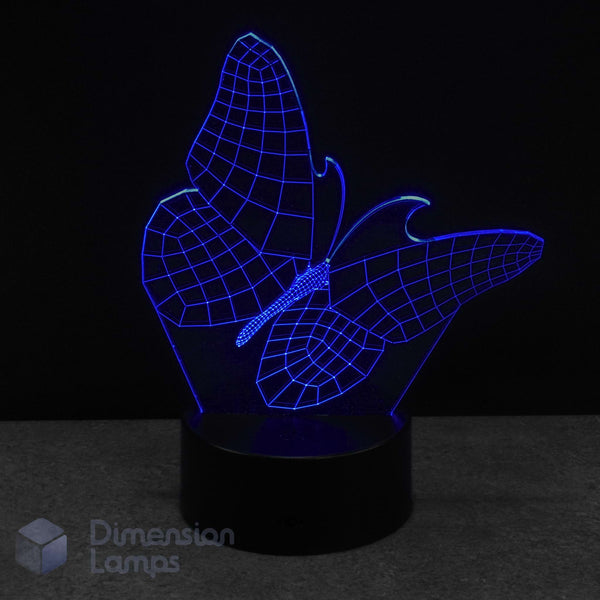 Butterfly-shaped night light with blue LED illumination on a dark background. Kids night light idea.