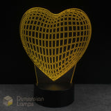 Wireframe heart-shaped lamp with grid pattern on a black background, branded 'Dimension Lamps'.