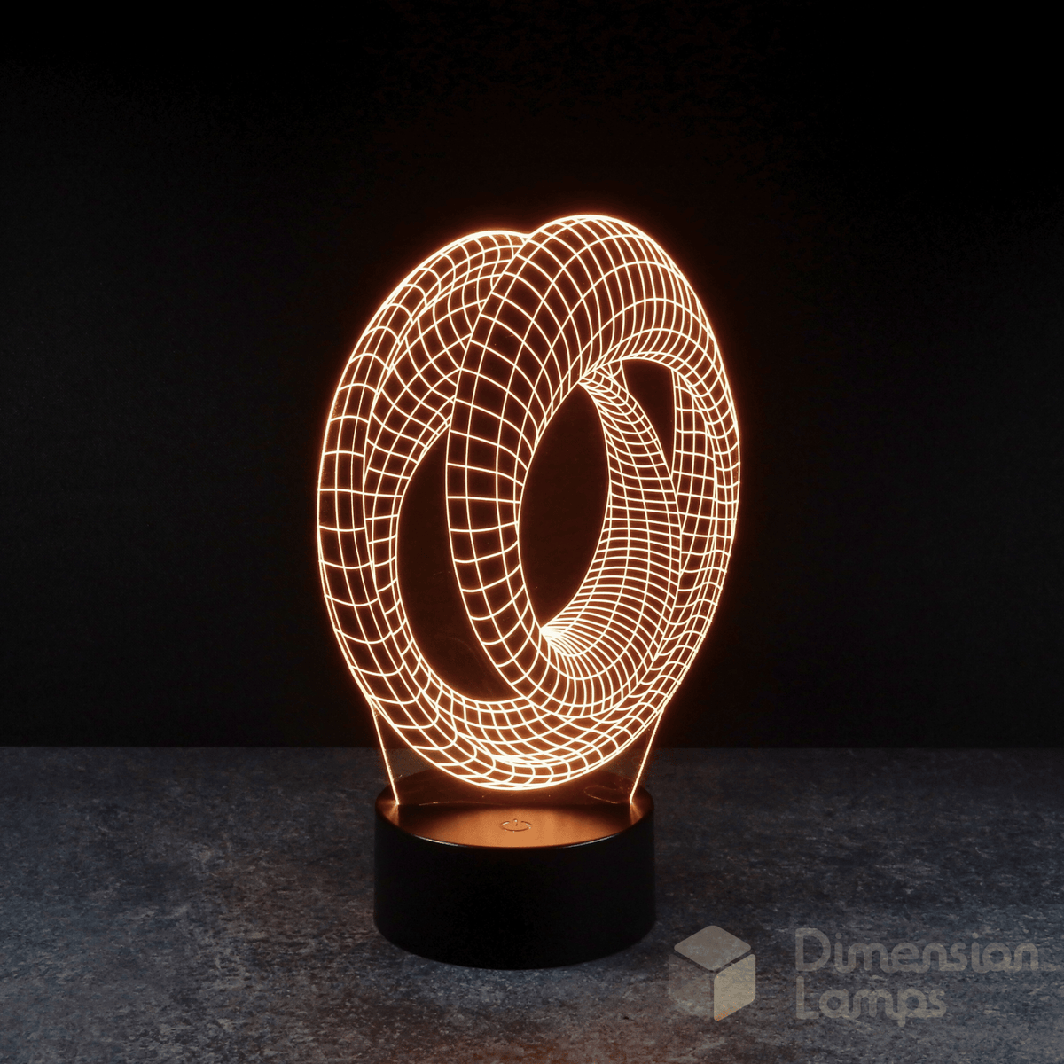 Mobius strip 3d night lamps: yellow illumination of a continuous looped geometric design on a lamp, rising from a base against a dark background. Marvel Avengers Endgame movie.