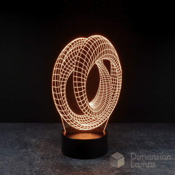 Mobius strip 3d night lamps: yellow illumination of a continuous looped geometric design on a lamp, rising from a base against a dark background. Marvel Avengers Endgame movie.