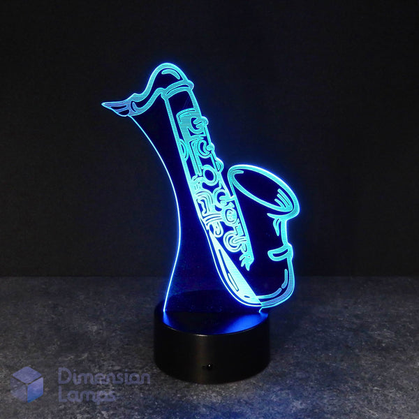 Cyan saxophone 3d night lamps: cyan illumination of a detailed saxophone outline on a lamp, rising from a base against a dark background. A unique 3d night lamp for saxophonists, musicians, and jazz fans. 