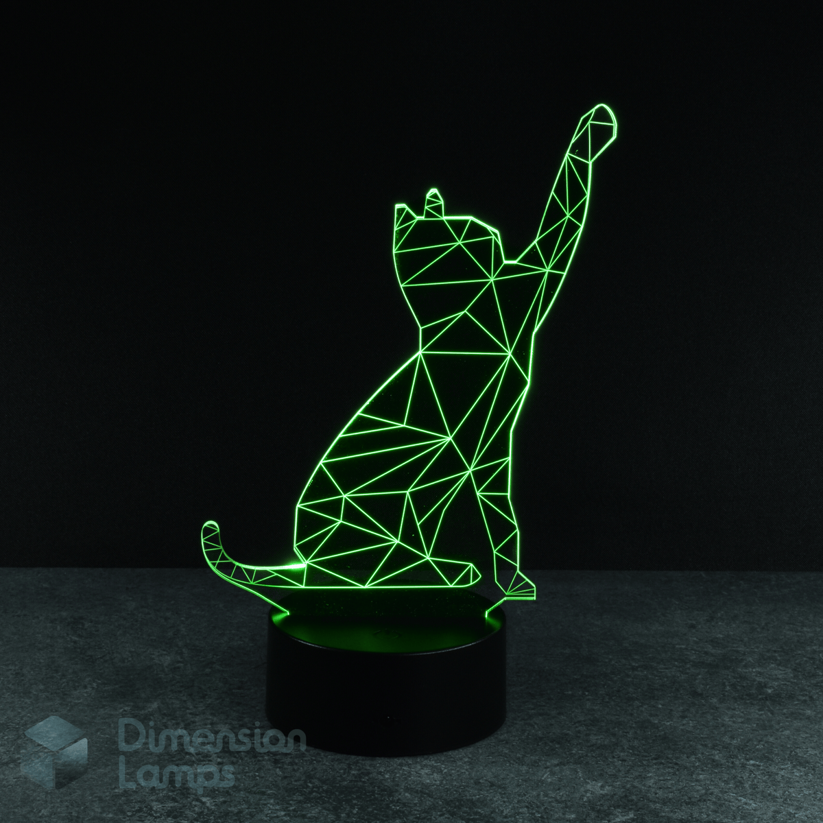 A green illuminated 3D lamp shows a geometric wireframe outline of a cat in a pawing motion, standing on a black base against a dark background. A playful gift idea for cat lovers in Australia. 