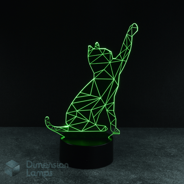 A green illuminated 3D lamp shows a geometric wireframe outline of a cat in a pawing motion, standing on a black base against a dark background. A playful gift idea for cat lovers in Australia. 