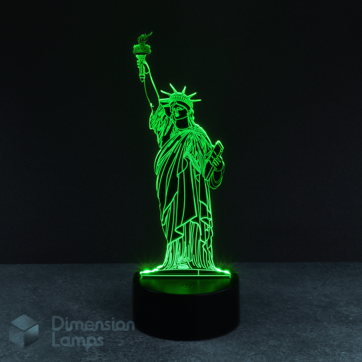 A 3D lamp on a black base illuminates the Statue of Liberty in green against a dark backdrop. This iconic New York landmark offers a touch of America for display across Australia.