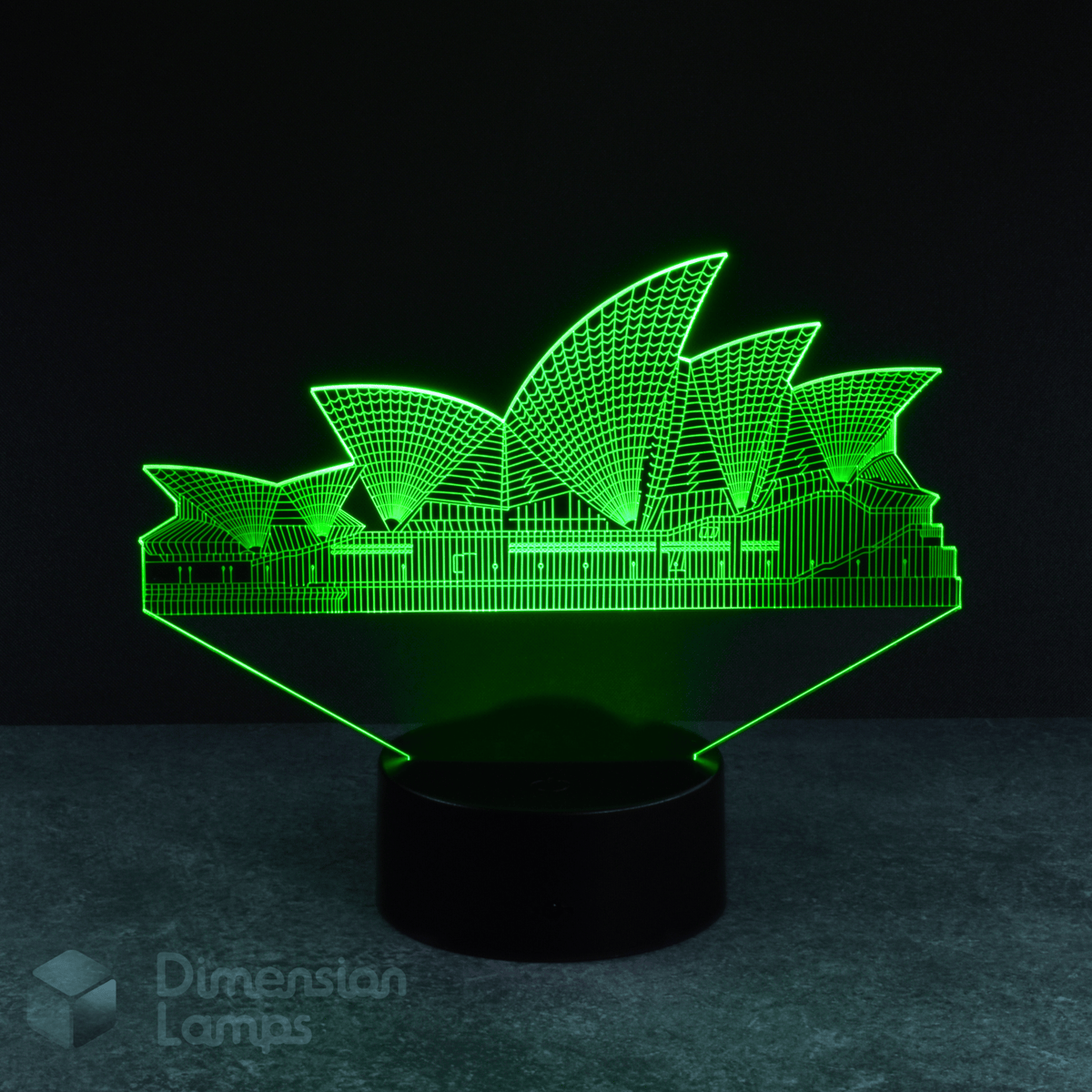 A 3D illusion lamp presents a detailed silhouette of the Sydney Opera House, a renowned Australian landmark, illuminated in green, emanating upwards from a black base against a dark background. A distinctive and engaging piece of Australiana. 