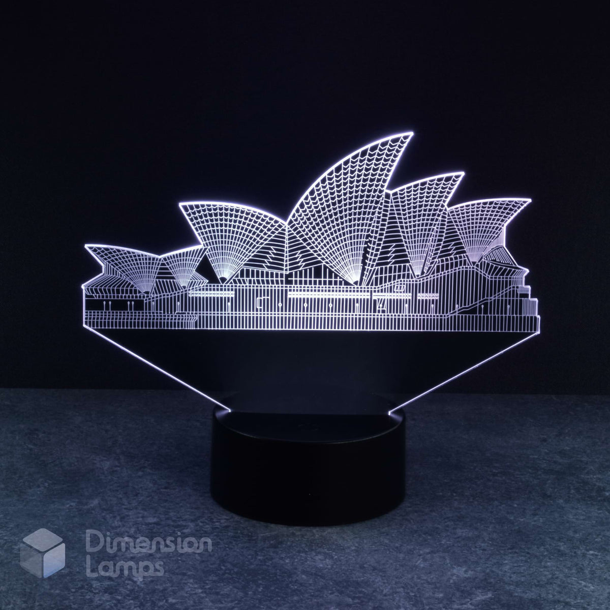 Sydney Opera House 3d night lamps: white illumination of the detailed architectural form of this iconic Australian landmark on a lamp, rising from a black base against a dark background. A thoughtful Australiana gift idea.