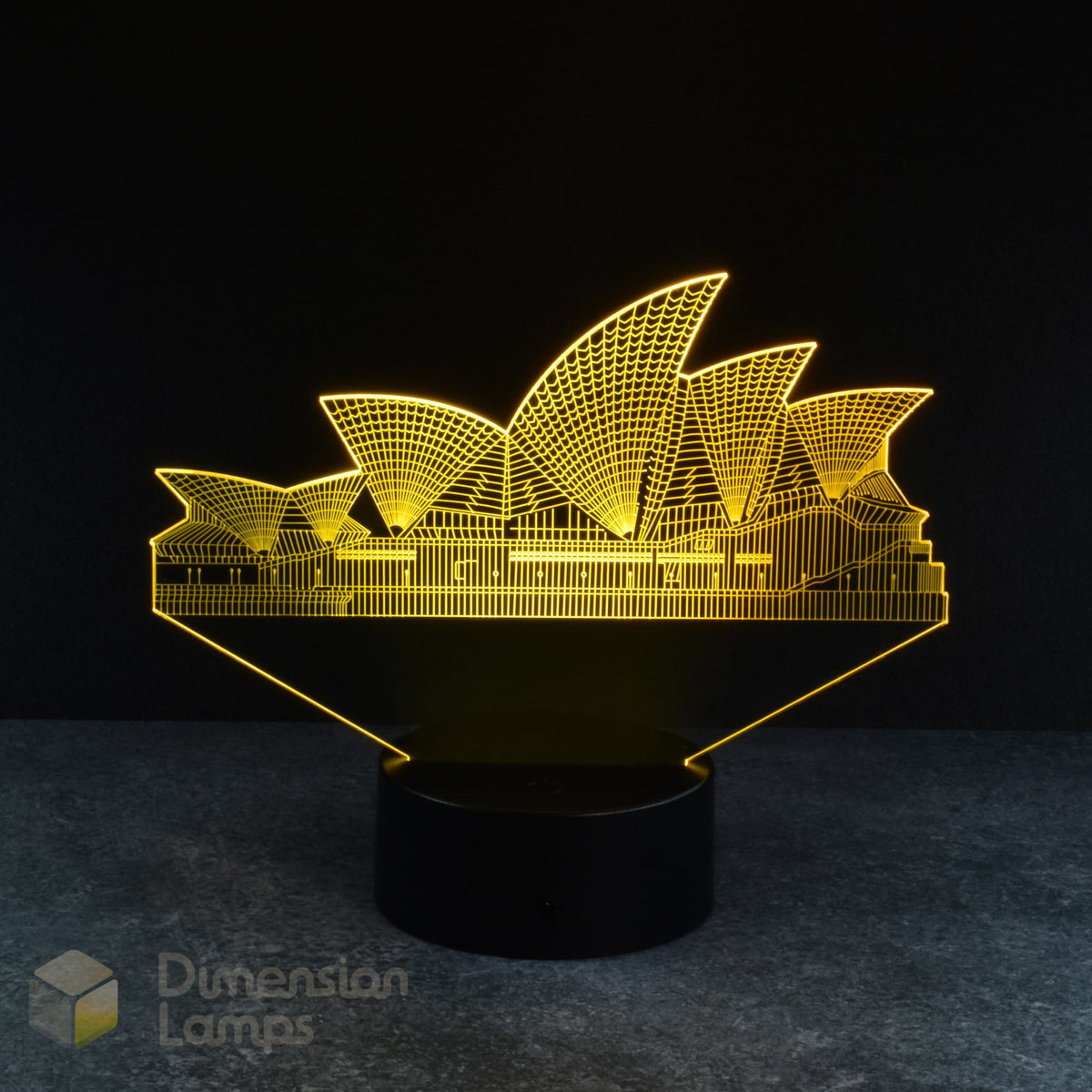 A yellow illuminated 3D lamp depicts the iconic Sydney Opera House, standing on a black base against a dark background. A recognisable landmark and piece of Australiana, perfect for homes across Australia.