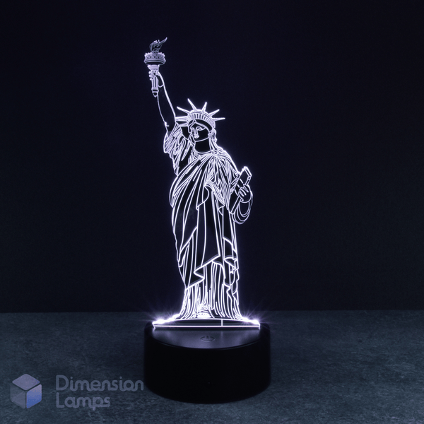 Set against a dark background, a brightly glowing white 3D lamp showcases the Statue of Liberty, positioned on a black base. This well-known New York icon is ideal for display throughout Australia.