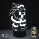 3D LED lamp with Santa Claus design and remote control on a dark background