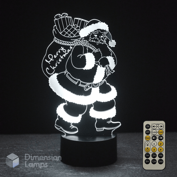 3D LED lamp with Santa Claus design and remote control on a dark background