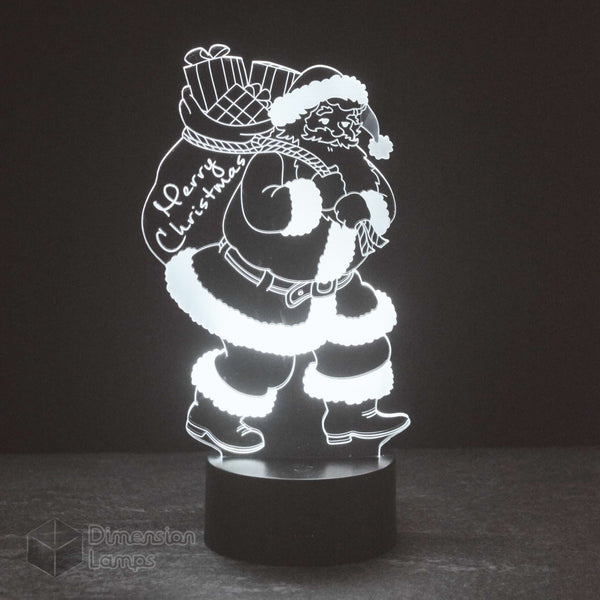 Santa Claus 3D lamp: unique Christmas lighting. Features a detailed Santa carrying a "Merry Christmas" sack, ideal for distinctive seasonal decor. 