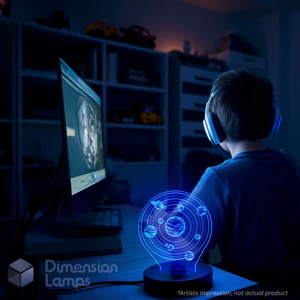 A child wearing white headphones sits at a desk in a dimly lit room, facing a computer monitor. In the foreground, a glowing holographic lamp displays a 3D orbital model of the solar system.
