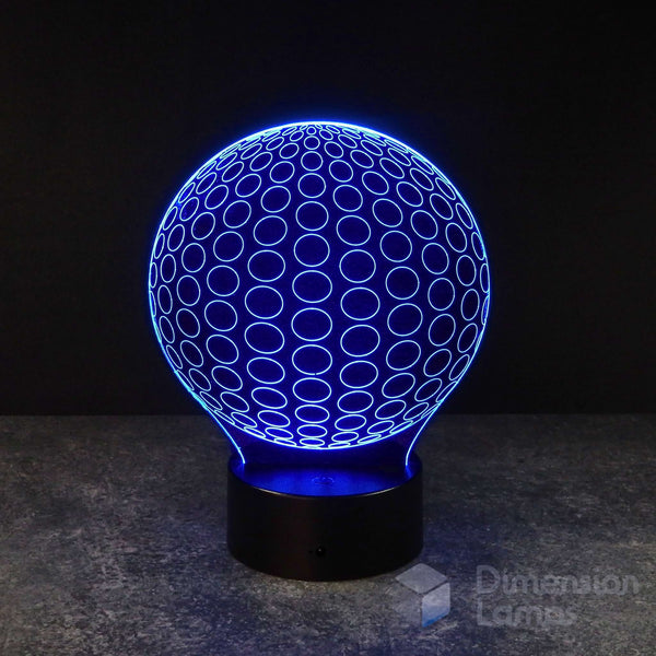 Australia: A 3D lamp displaying a symmetrical pattern of radial circles, illuminated in blue, forming a spherical shape on a black base against a dark background. A useful study aid and visually balanced night light.